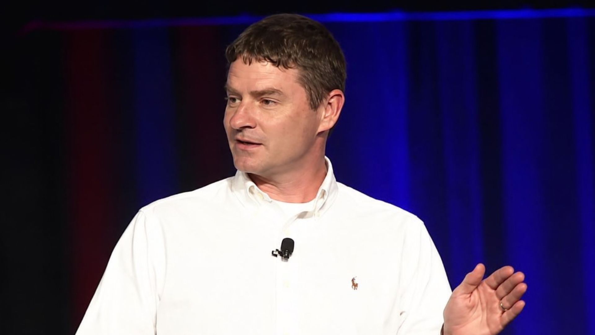 Ted Stevenot delivering a general-session conference presentation before a large audience.